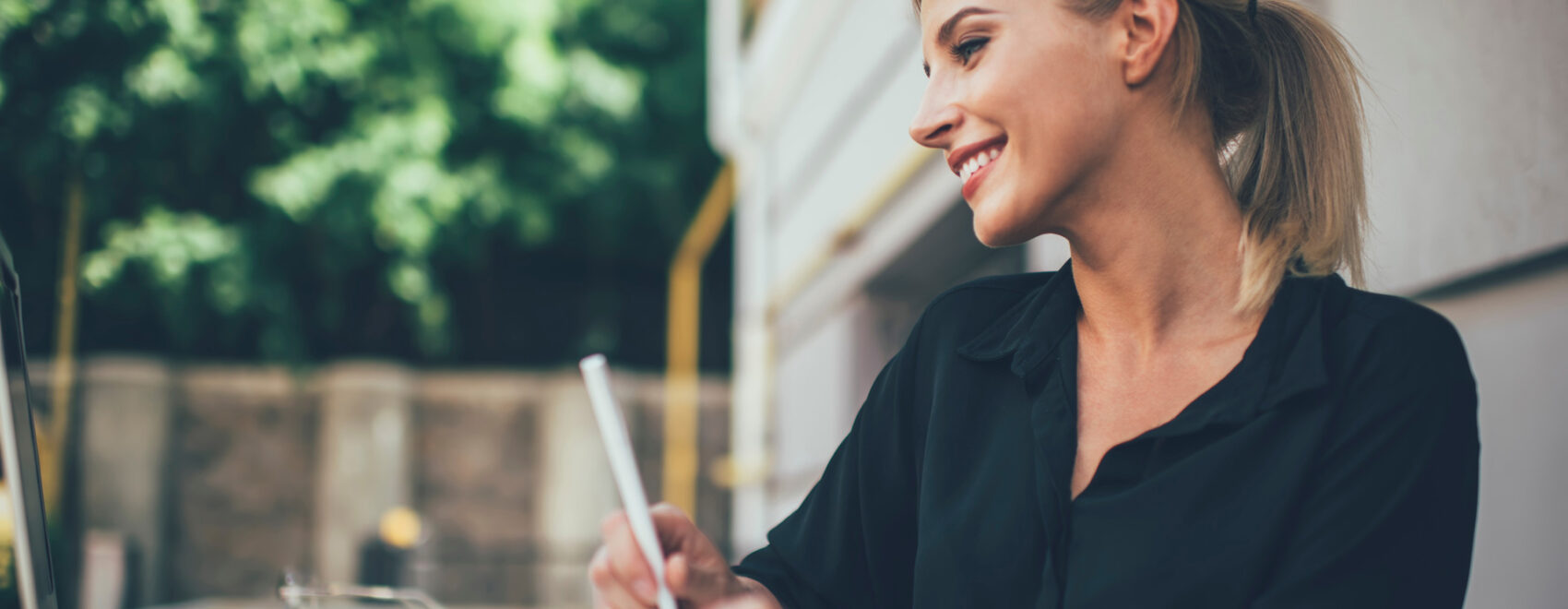 Photo of a women on a desk looking at a computer