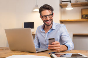 man-on-phone-and-laptop