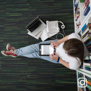 Female student using tablet in library