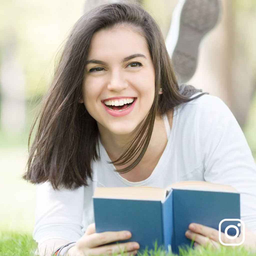 Young woman reading a book outside