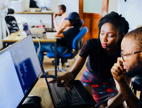 Photo of people looking at a computer