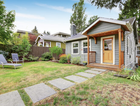 Grey old house with wooden trim
